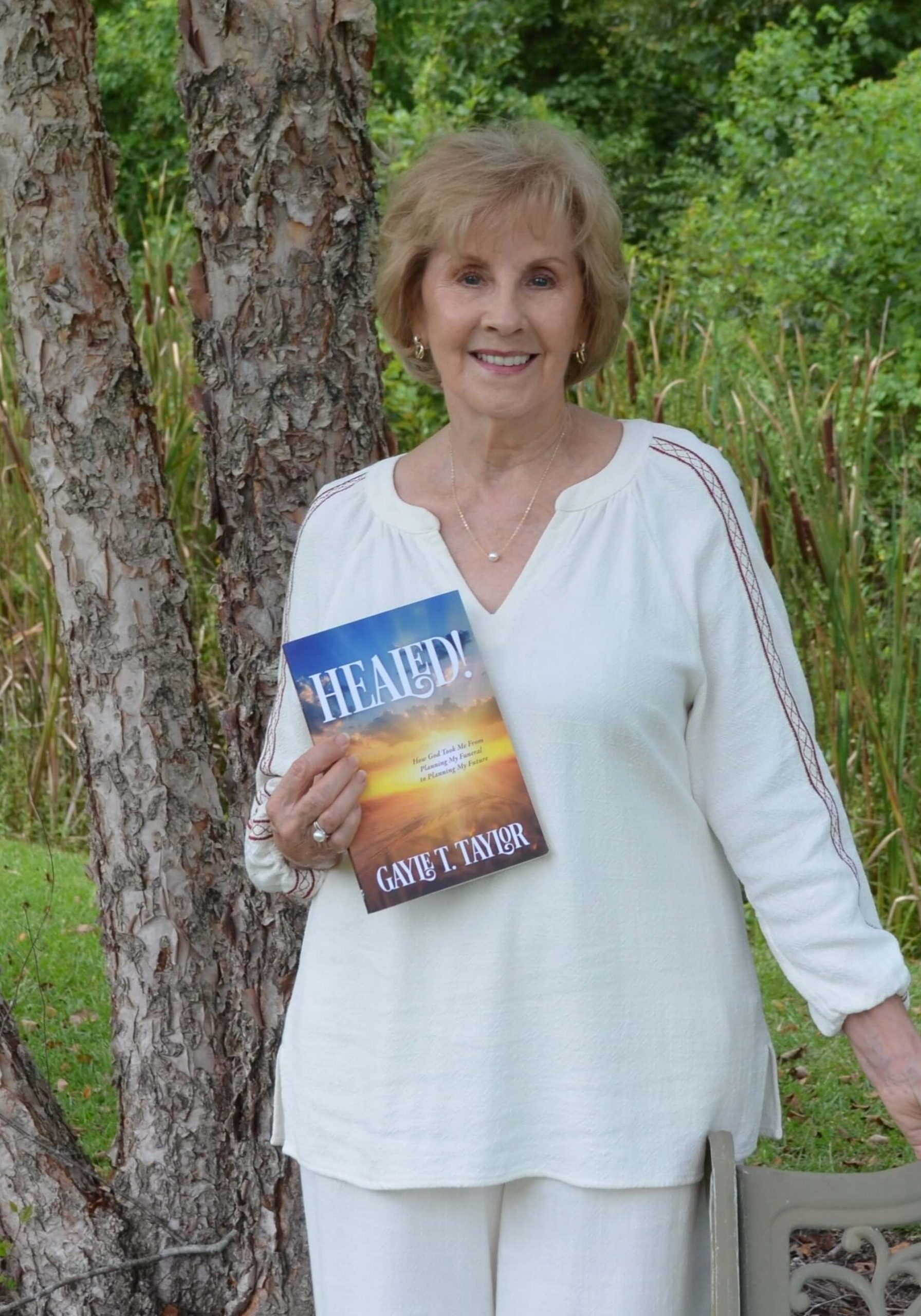 Gayle Taylor holding her book Healed!