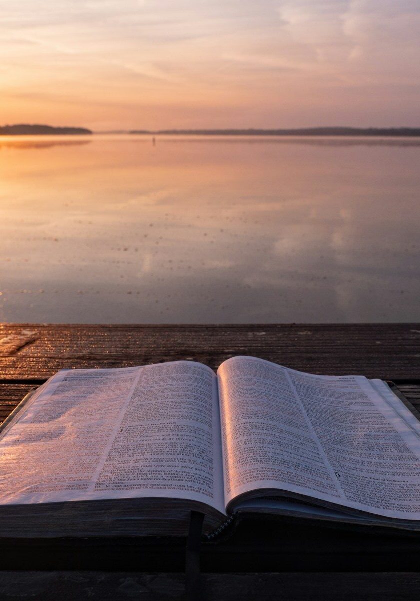 book on top of table and body of water